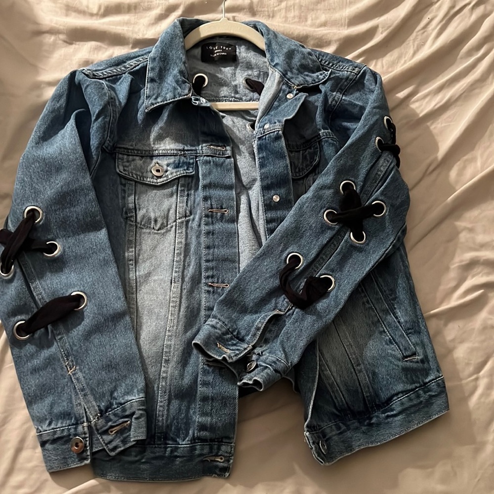 Jean jacket with cross ties on sleeve and back by “Love Tree”